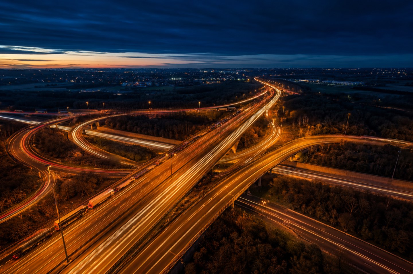 A motorway interchange at dusk with light trails